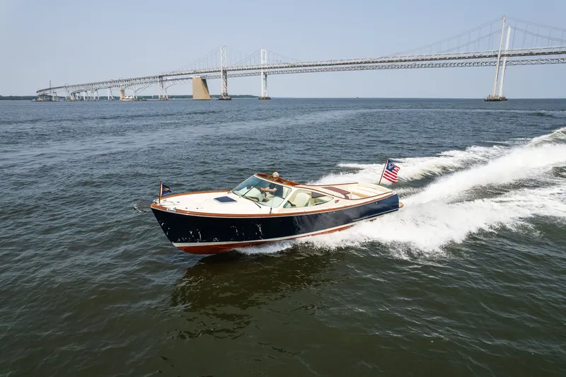 Slide: The Image of 2008 Hinckley Talaria 29R cruising on water near a large bridge. - 9