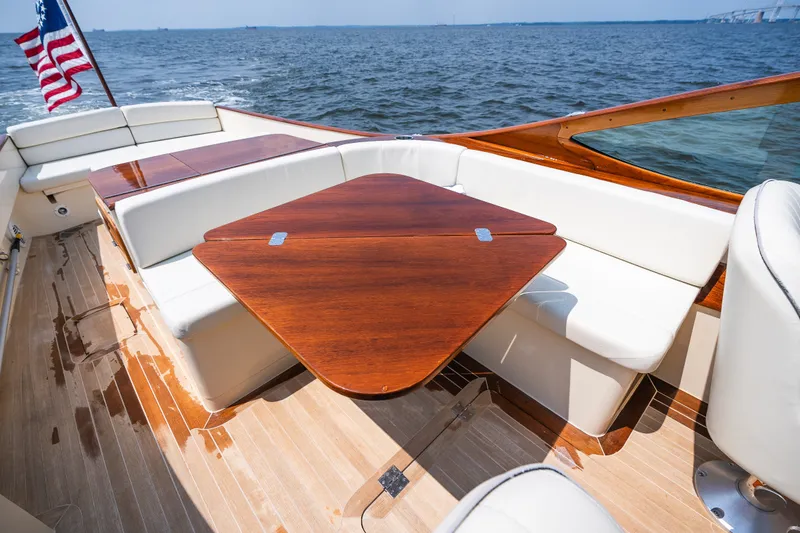 Slide: The Image of Luxurious 2008 Hinckley Talaria 29R yacht interior with wooden table and white seating. - 36
