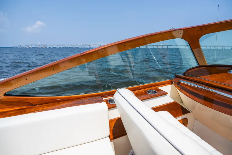 Slide: The Image of 2008 Hinckley Talaria 29R boat interior with wooden accents, overlooking a scenic water view. - 27