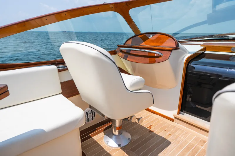 Slide: The Image of Interior of 2008 Hinckley Talaria 29R boat with elegant seating and wooden dashboard. - 26