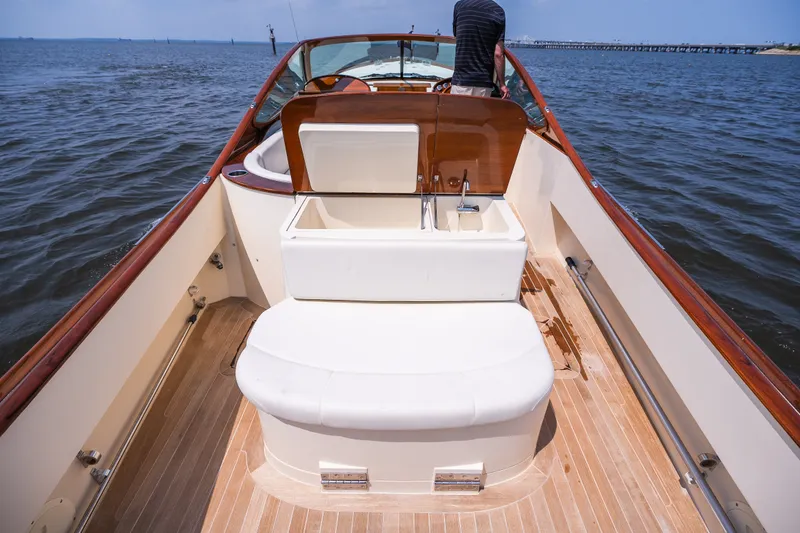 Slide: The Image of 2008 Hinckley Talaria 29R boat interior with wooden deck and seating, on open water. - 41