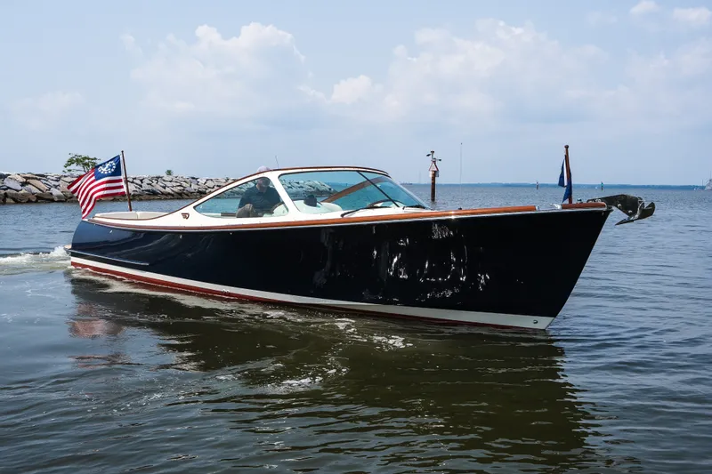 Slide: The Image of 2008 Hinckley Talaria 29R cruising on calm waters with American flag. - 2