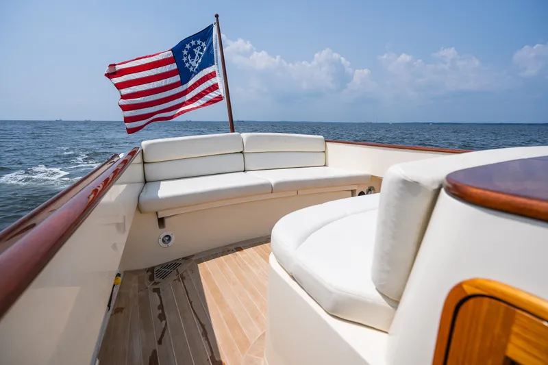 Slide: The Image of 2008 Hinckley Talaria 29R yacht with American flag, elegant seating, and ocean view. - 39