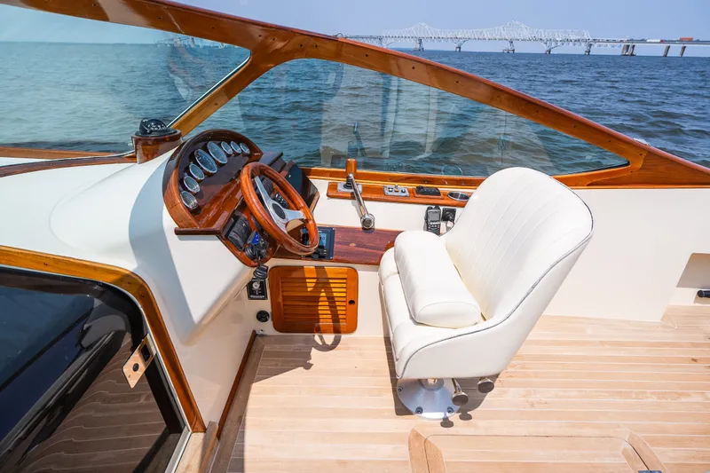 Slide: The Image of Helm of 2008 Hinckley Talaria 29R yacht with wooden accents and white captain's chair. - 20