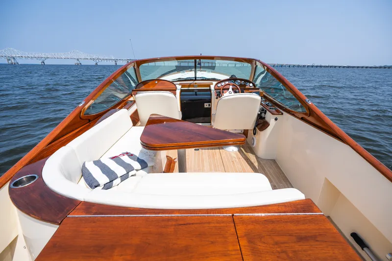 Slide: The Image of 2008 Hinckley Talaria 29R boat interior with wooden accents on open water. - 35