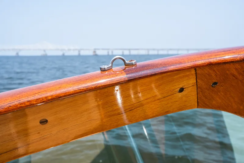 Slide: The Image of 2008 Hinckley Talaria 29R boat detail with polished wood and ocean backdrop. - 28