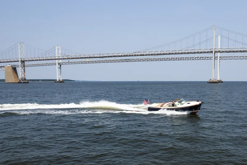 Slide: The Image of 2008 Hinckley Talaria 29R cruising under a large suspension bridge on a sunny day. - 8