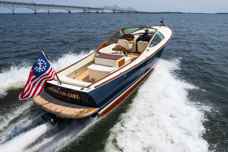 Slide: The Image of 2008 Hinckley Talaria 29R cruising on water with bridge in background. - 3