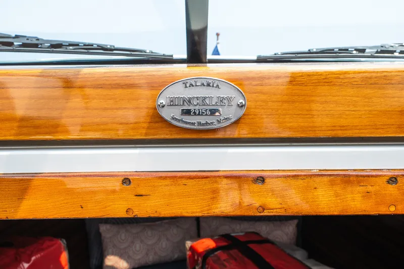 Slide: The Image of 2008 Hinckley Talaria 29R boat with polished wood finish and engraved nameplate. - 31