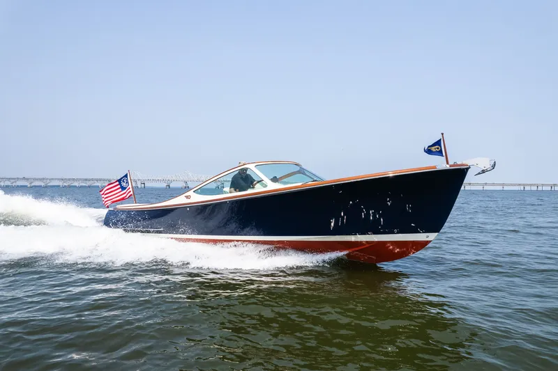 The Image of 2008 Hinckley Talaria 29R cruising on open water with American flag. - 0