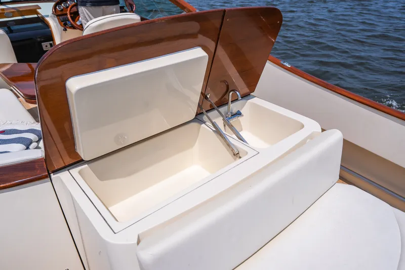 Slide: The Image of Luxury sink area on 2008 Hinckley Talaria 29R boat, featuring elegant wood finish. - 40