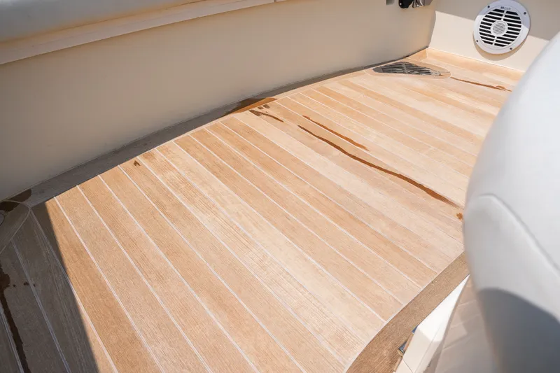 Slide: The Image of Teak deck of 2008 Hinckley Talaria 29R boat, featuring clean lines and speaker detail. - 42