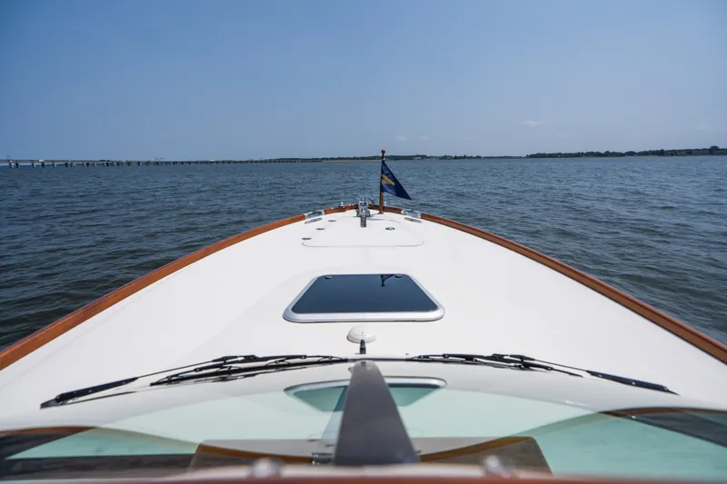 Slide: The Image of Bow view of 2008 Hinckley Talaria 29R cruising on open water under clear skies. - 25