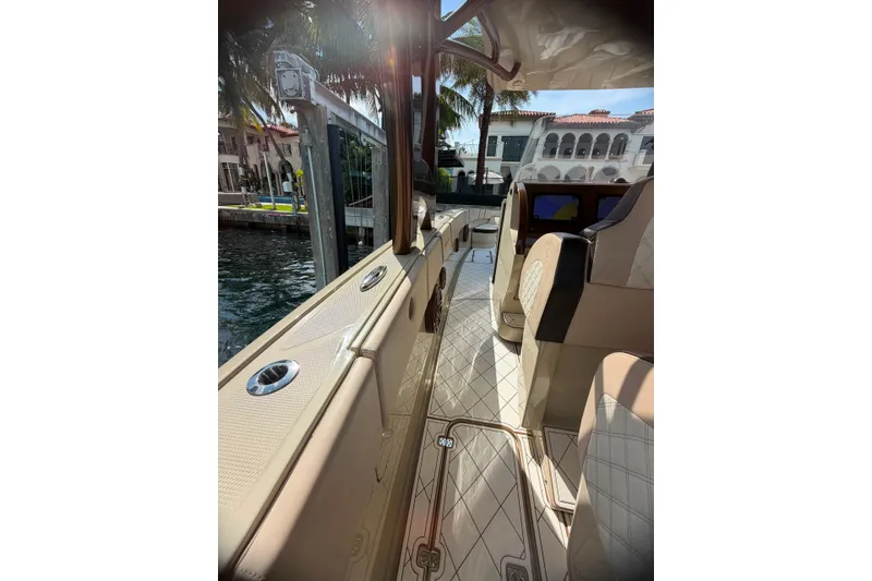 Slide: The Image of 2019 Midnight Express 43 Open boat interior with luxurious seating and waterfront view. - 2