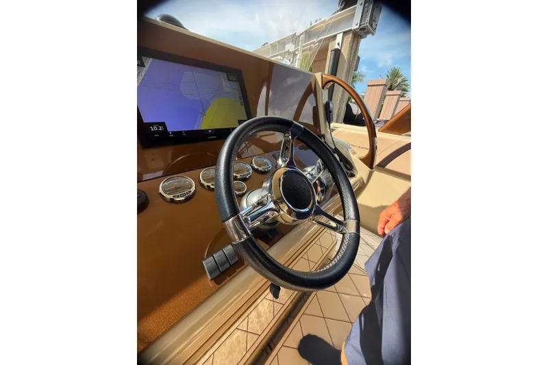 Slide: The Image of Steering wheel and dashboard of 2019 Midnight Express 43 Open boat with navigation display. - 9
