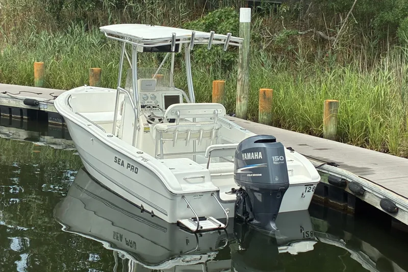 Slide: The Image of 2004 Sea Pro 206 Center Console boat docked with Yamaha 150 engine. - 2