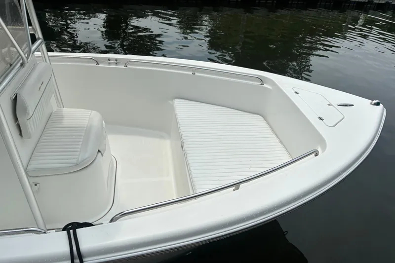 Slide: The Image of 2004 Sea Pro 206 Center Console boat interior with white seating and railing. - 7