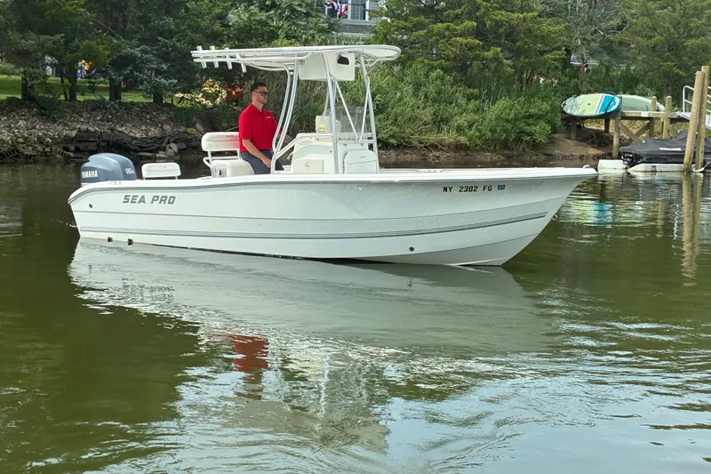 Slide: The Image of 2004 Sea Pro 206 Center Console boat on calm water, with trees in the background. - 4