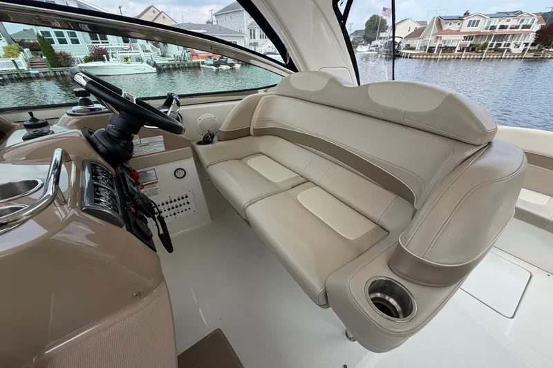 Slide: The Image of Interior of a 2016 Formula 37 Performance Cruiser with beige seating and helm. - 11