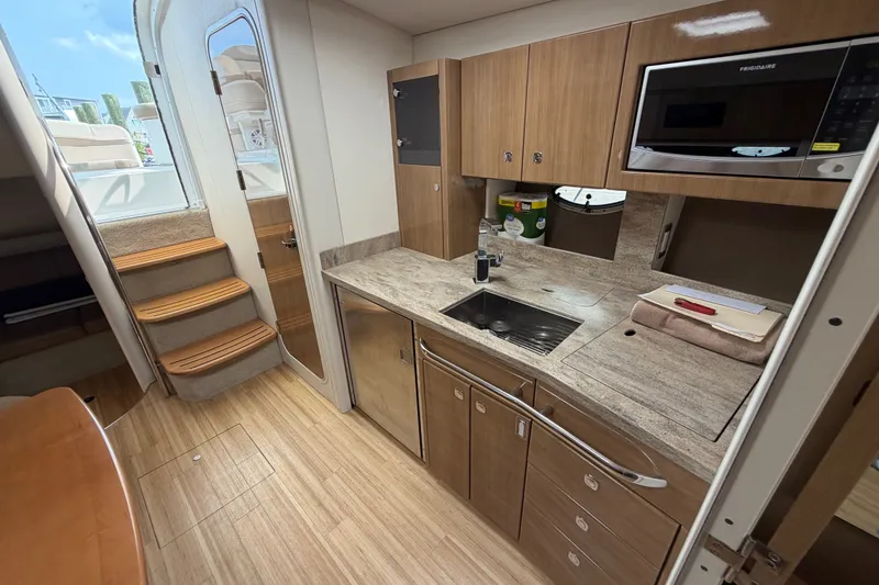 Slide: The Image of Interior of 2016 Formula 37 Performance Cruiser with modern kitchen and wooden cabinetry. - 27