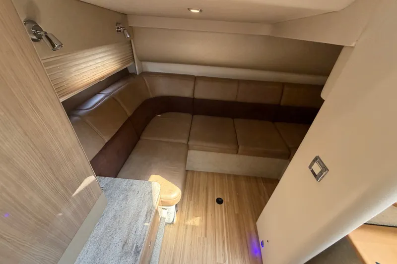 Slide: The Image of Interior of 2016 Formula 37 Performance Cruiser with beige leather seating and wood flooring. - 32
