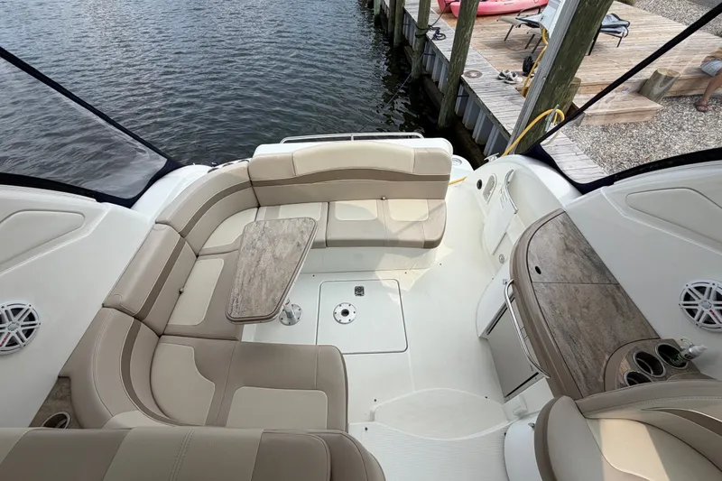 Slide: The Image of 2016 Formula 37 Performance Cruiser interior with beige seating and wooden accents by the water. - 9
