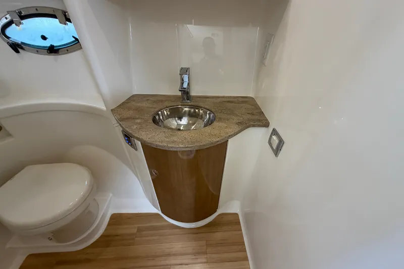 Slide: The Image of 2016 Formula 37 Performance Cruiser bathroom with sink, toilet, and porthole window. - 30