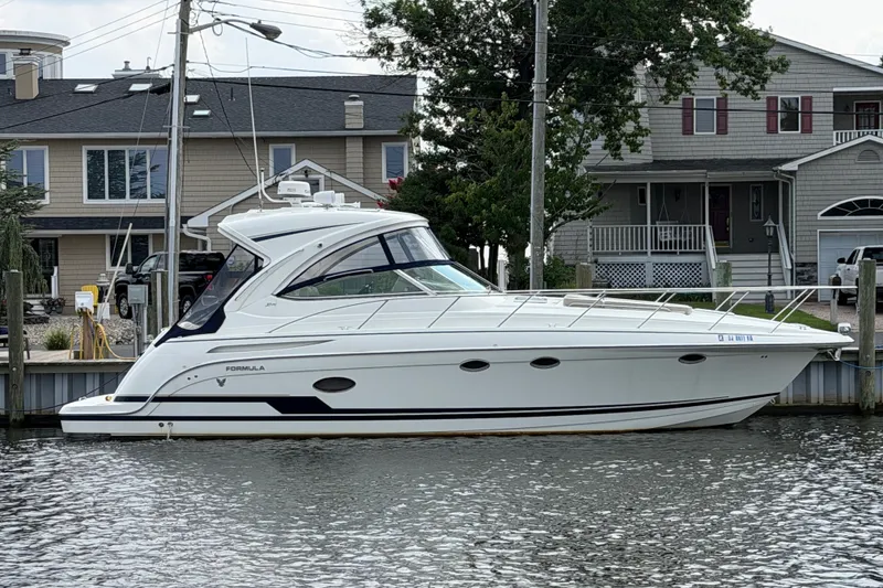 Slide: The Image of 2016 Formula 37 Performance Cruiser docked near waterfront homes. - 2