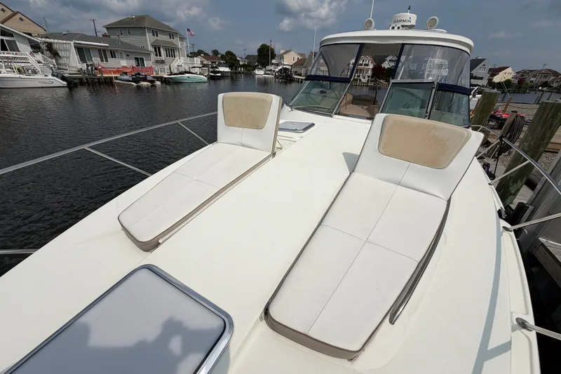 Slide: The Image of 2016 Formula 37 Performance Cruiser with sun loungers docked in a residential marina. - 42
