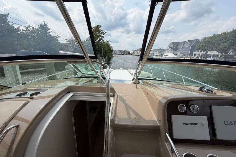Slide: The Image of 2016 Formula 37 Performance Cruiser cockpit view, showcasing sleek design and waterfront scenery. - 37