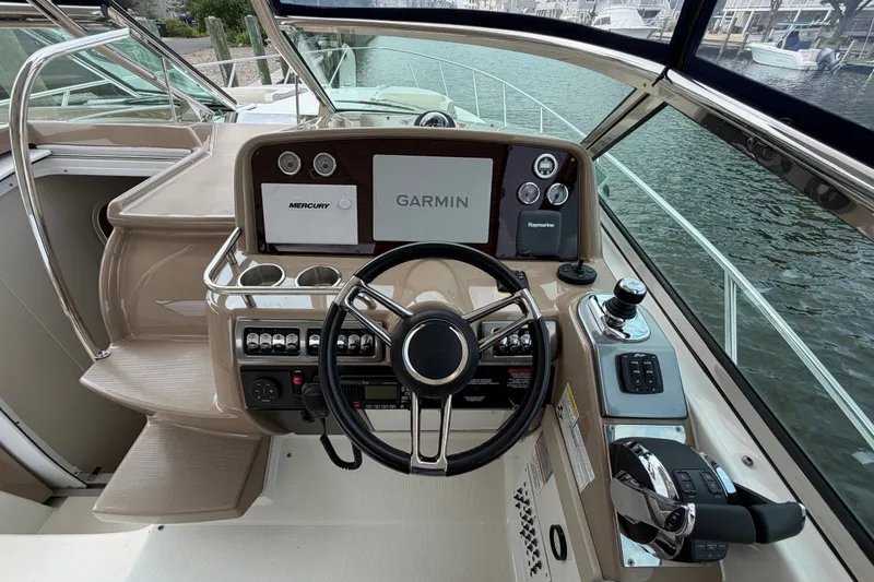 Slide: The Image of Helm of 2016 Formula 37 Performance Cruiser with Garmin and Mercury controls, dockside view. - 13