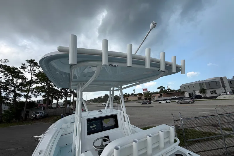 Slide: The Image of 2027 Contender 30 ST boat with rod holders and navigation system under cloudy sky. - 33