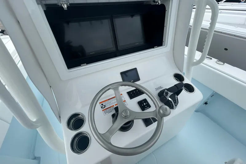 Slide: The Image of Contender 30 ST 2027 boat dashboard with steering wheel and dual screens. - 18