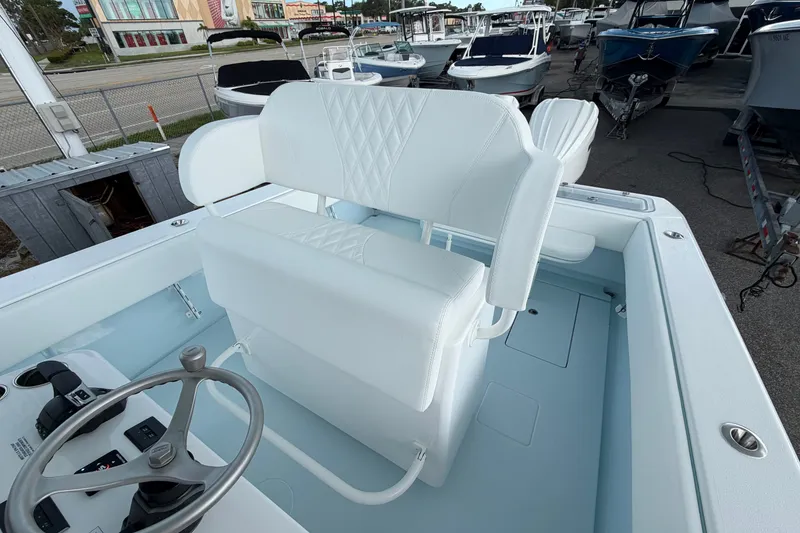 Slide: The Image of 2027 Contender 30 ST boat interior with white seating and steering wheel. - 30