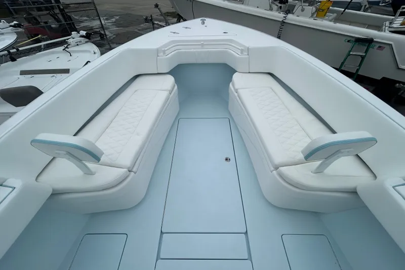 Slide: The Image of 2027 Contender 30 ST boat interior with white cushioned seating and spacious deck. - 19