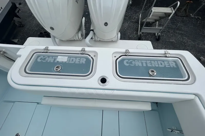 Slide: The Image of 2027 Contender 30 ST boat with dual outboard engines and branded storage compartments. - 25
