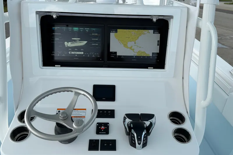 Slide: The Image of Dashboard of a 2027 Contender 30 ST boat with navigation screens and controls. - 13