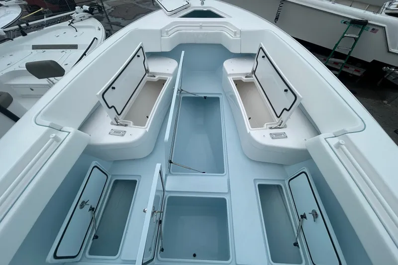 Slide: The Image of 2027 Contender 30 ST boat interior with open storage compartments, showcasing spacious design. - 23