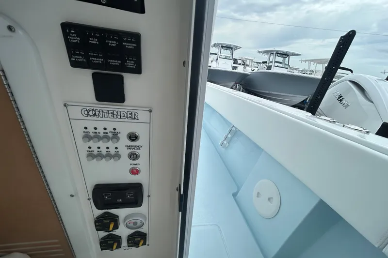 Slide: The Image of Control panel of a 2027 Contender 30 ST boat, showcasing switches and controls. - 22