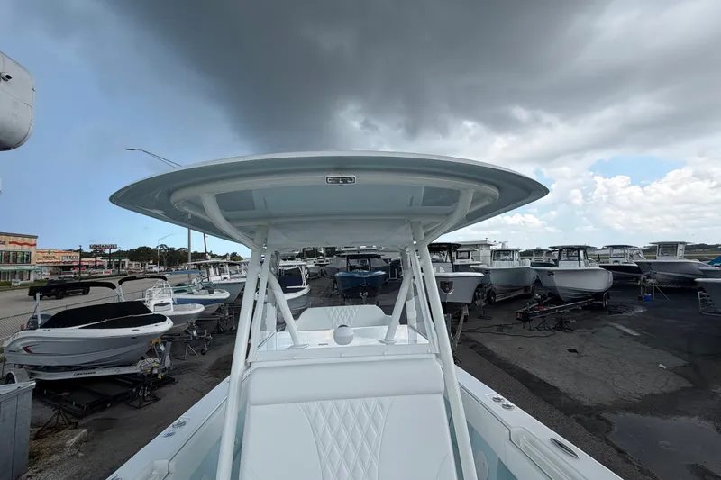 Slide: The Image of 2027 Contender 30 ST boat in a marina under cloudy skies. - 34