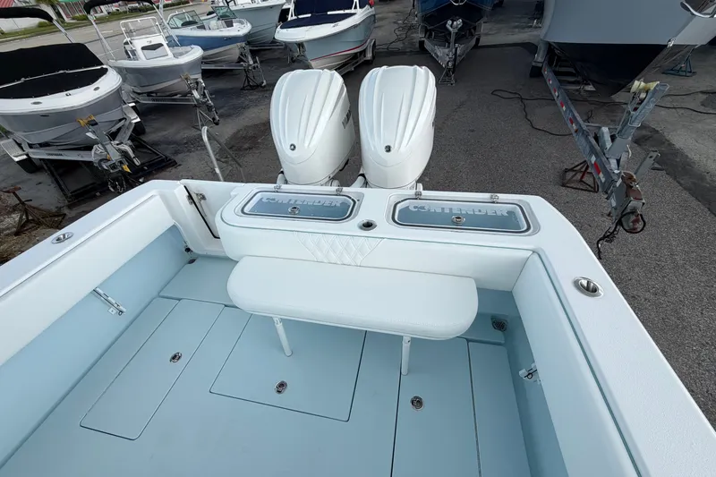 Slide: The Image of 2027 Contender 30 ST boat with dual engines, docked among other boats. - 31