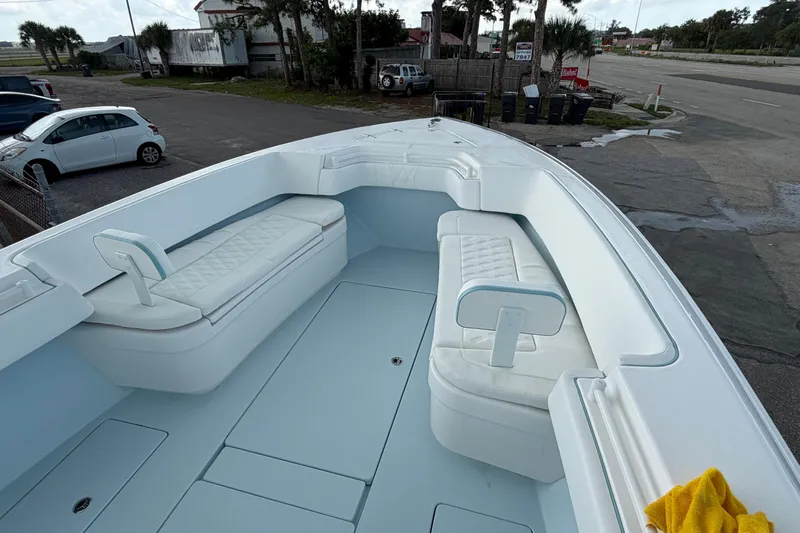 Slide: The Image of 2027 Contender 30 ST boat interior with white cushioned seating and spacious deck. - 28