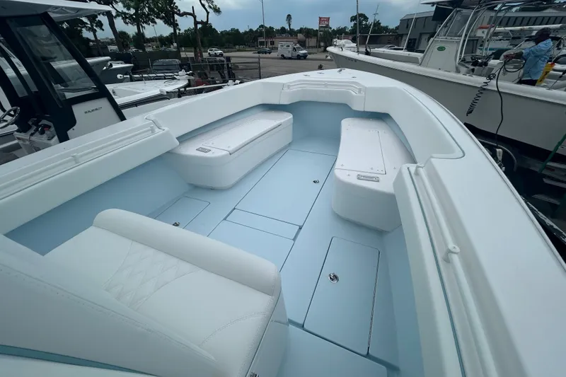 Slide: The Image of 2027 Contender 30 ST boat interior with white seating and storage compartments. - 17