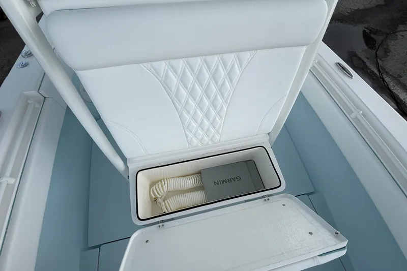 Slide: The Image of 2027 Contender 30 ST boat seat storage with Garmin equipment and coiled rope. - 35