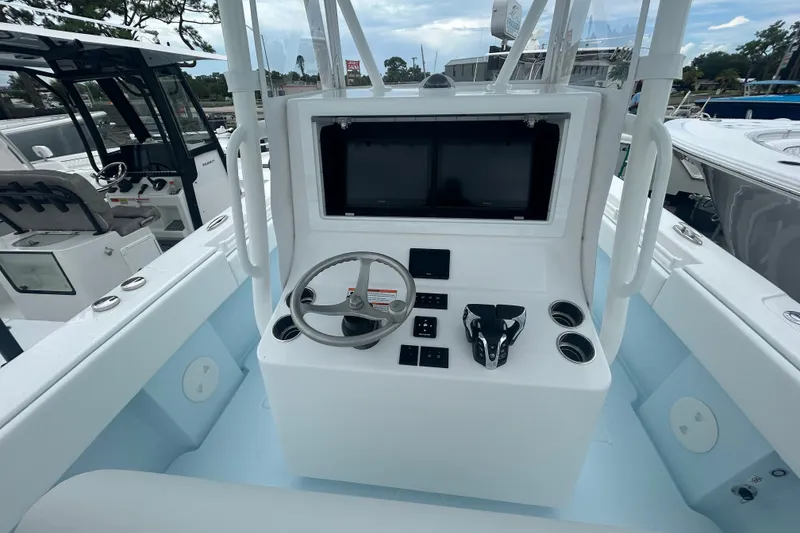 Slide: The Image of 2027 Contender 30 ST boat console with steering wheel and dual screens. - 16