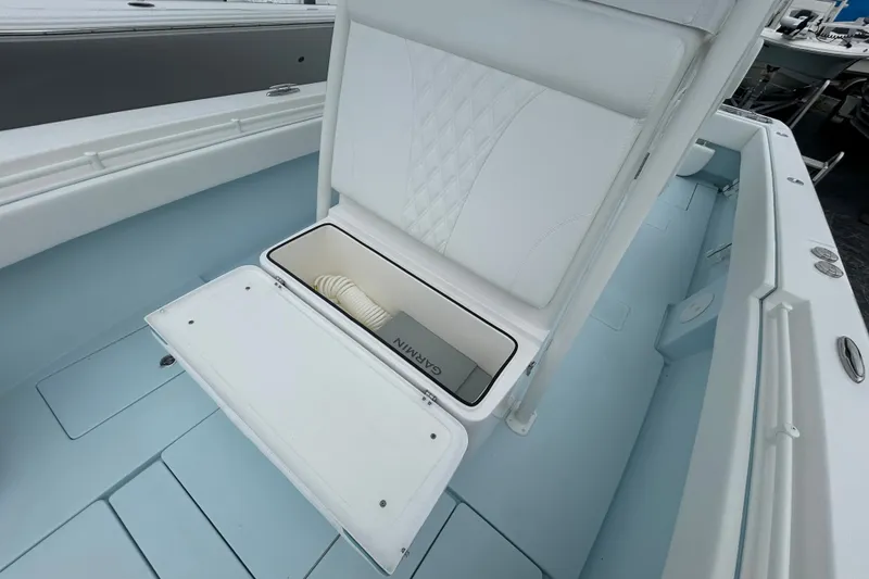 Slide: The Image of 2027 Contender 30 ST boat interior with open storage compartment and white seating. - 24