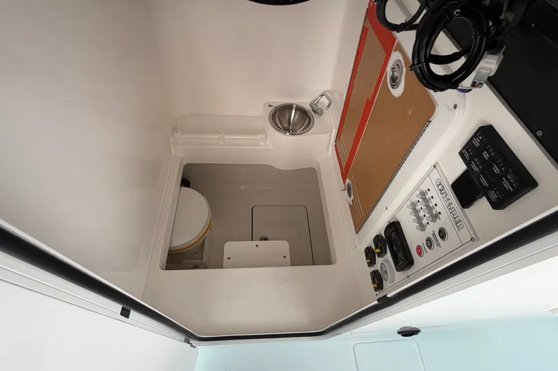 Slide: The Image of Interior of 2027 Contender 30 ST boat featuring control panel and compact sink. - 36