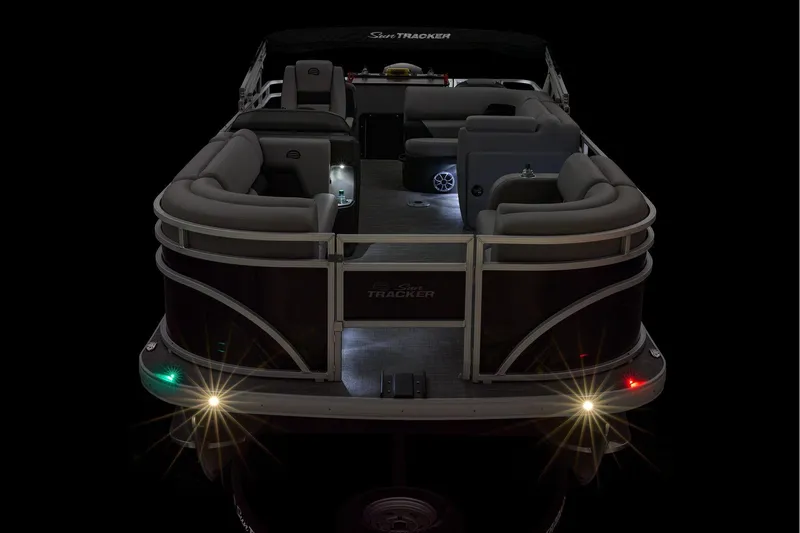 Slide: The Image of Manufacturer Provided Image: 2026 Sun Tracker SportFish 22 DLX pontoon boat with illuminated deck and seating. - 18