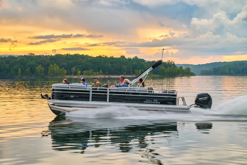 Slide: The Image of Manufacturer Provided Image: 2026 Sun Tracker SportFish 22 DLX pontoon boat cruising on a serene lake at sunset. - 72