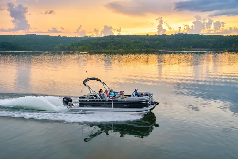 Slide: The Image of Manufacturer Provided Image: 2026 Sun Tracker SportFish 22 DLX cruising on a serene lake at sunset. - 71